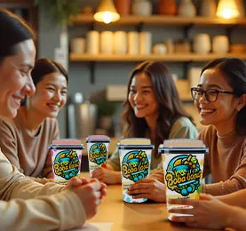 Group of friends enjoying Bobalicious bubble tea together at a cozy cafe.