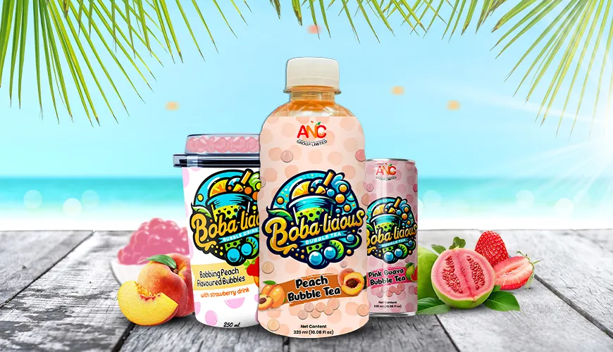 Bobalicious peach bubble tea drinks in cup, can, and bottle packaging displayed with tropical fruits by the beach.
