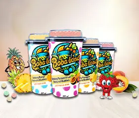 A colorful display of Bobalicious mini cups arranged on a summer-themed backdrop with tropical fruit vibes.