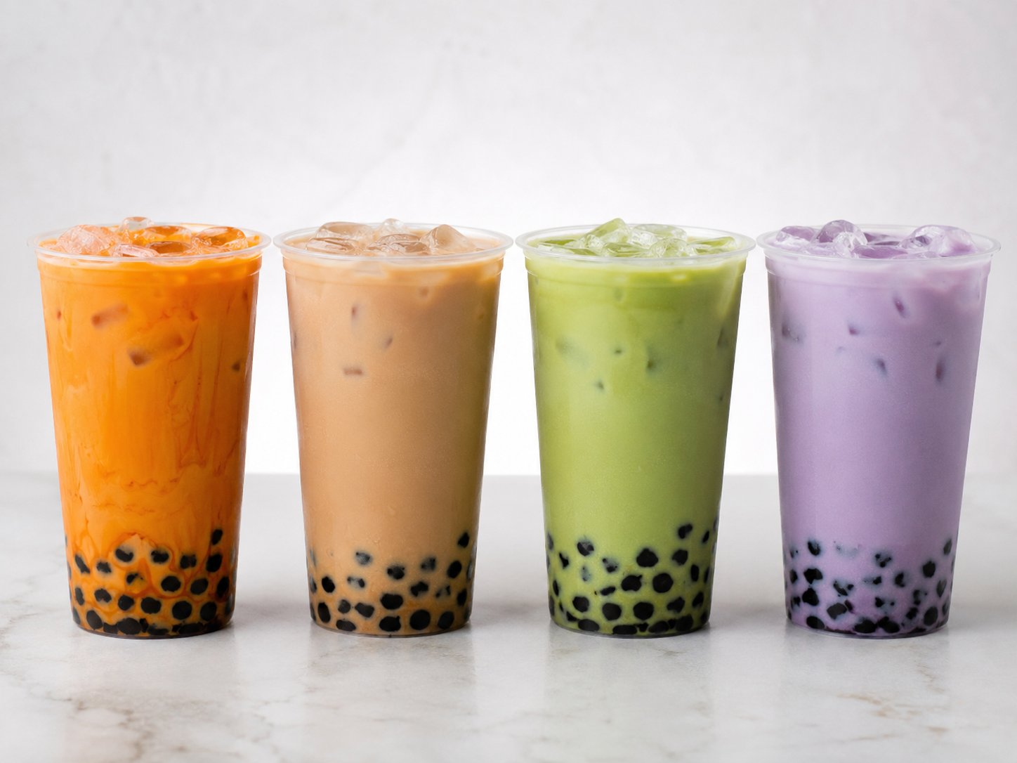 Thai milk tea beside classic milk tea, matcha milk tea, and taro milk tea