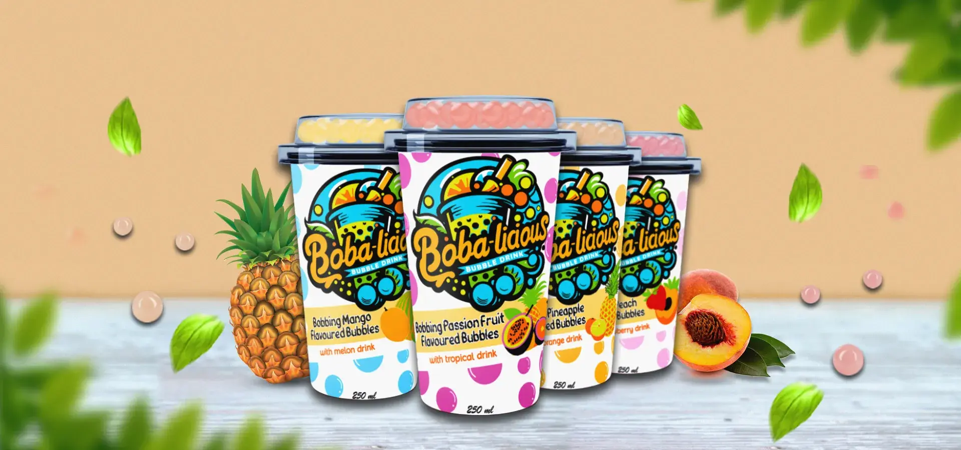 Bobalicious bubble tea cups lined up in tropical flavours, surrounded by fruits and floating tea bubbles.
